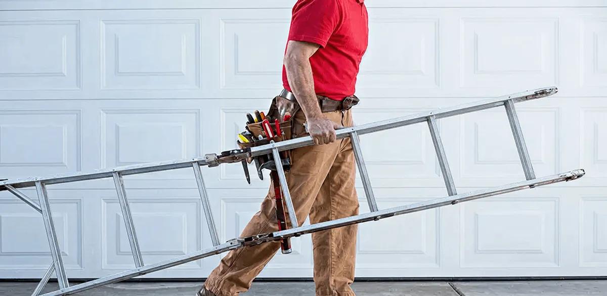 Garage door repair technician arriving with tools and ladder in Seattle, WA