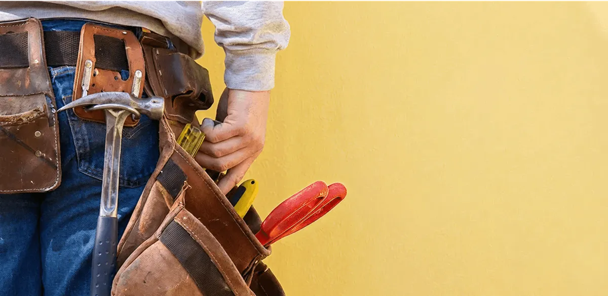 Handyman with tool belt ready for home repairs and maintenance in Seattle, WA